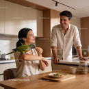 Couple sharing a moment with a parrot in modern kitchen
