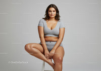 Plus Size Woman Sitting on Stool in Casual Gray Outfit