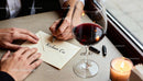 Romantic handwritten love note with wine and candlelight