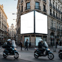 Busy urban street corner with blank billboard and commuters