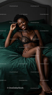 Smiling woman relaxing on bed in black lace lingerie