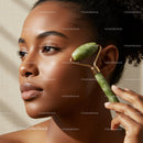 Elegant Black Woman Using Jade Roller for a Natural Skincare Routine