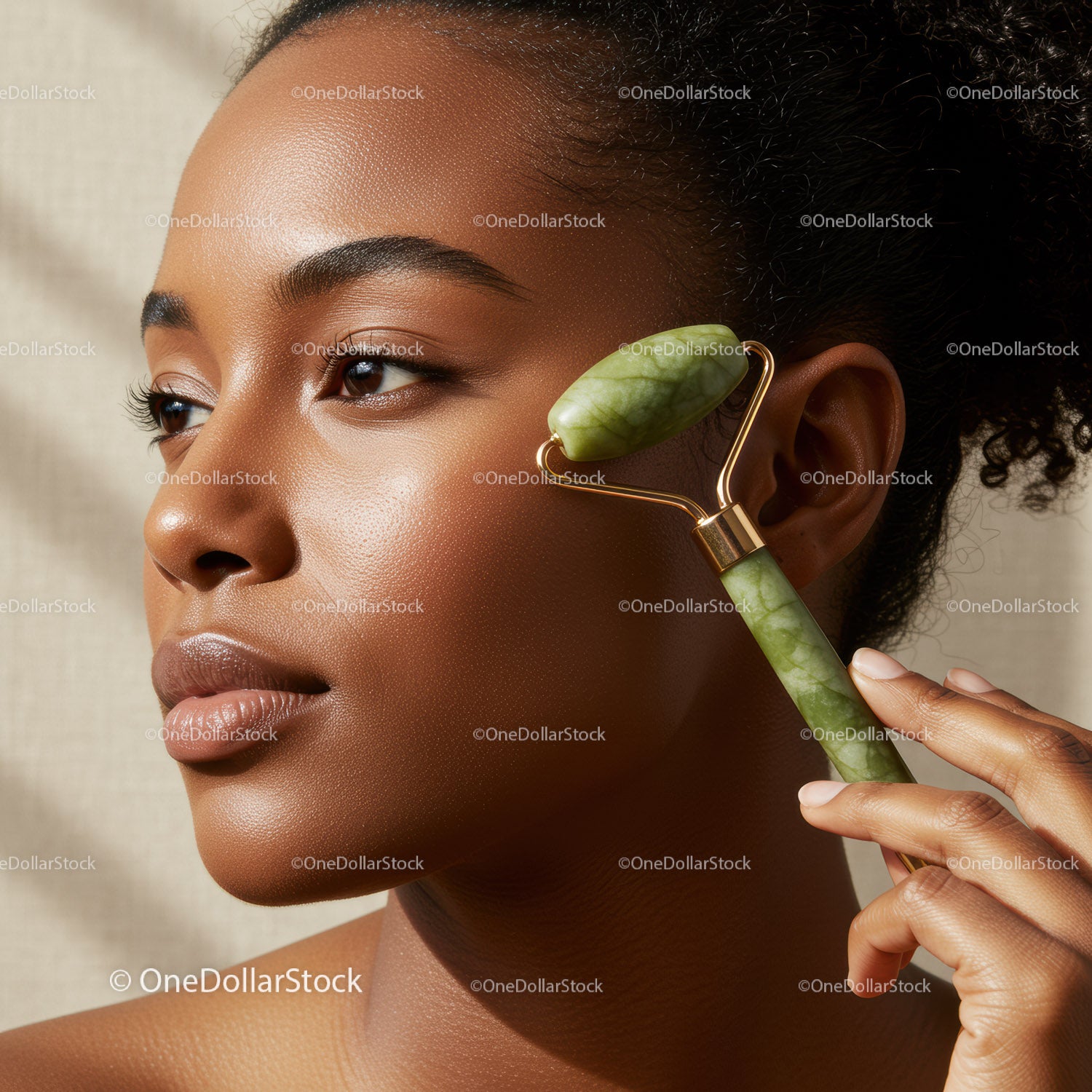 Elegant Black Woman Using Jade Roller for a Natural Skincare Routine