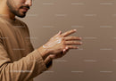 Man Applying Sunscreen Lotion on Hand for Skin Protection