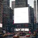 Busy New York City street with large blank billboard
