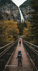 Scenic Mountain Waterfall with Forest Trail and Family Hikers