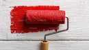 Red Paint on White Wooden Surface Using Paint Roller for Wall Decoration