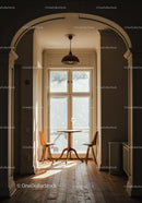 Sunlit cozy dining nook with wooden table and chairs