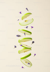 Floating green apple slices with purple flowers