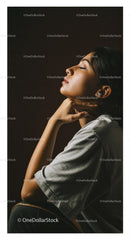 Elegant Woman in Profile with Soft Lighting Against Dark Background