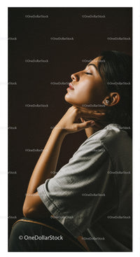 Elegant Woman in Profile with Soft Lighting Against Dark Background