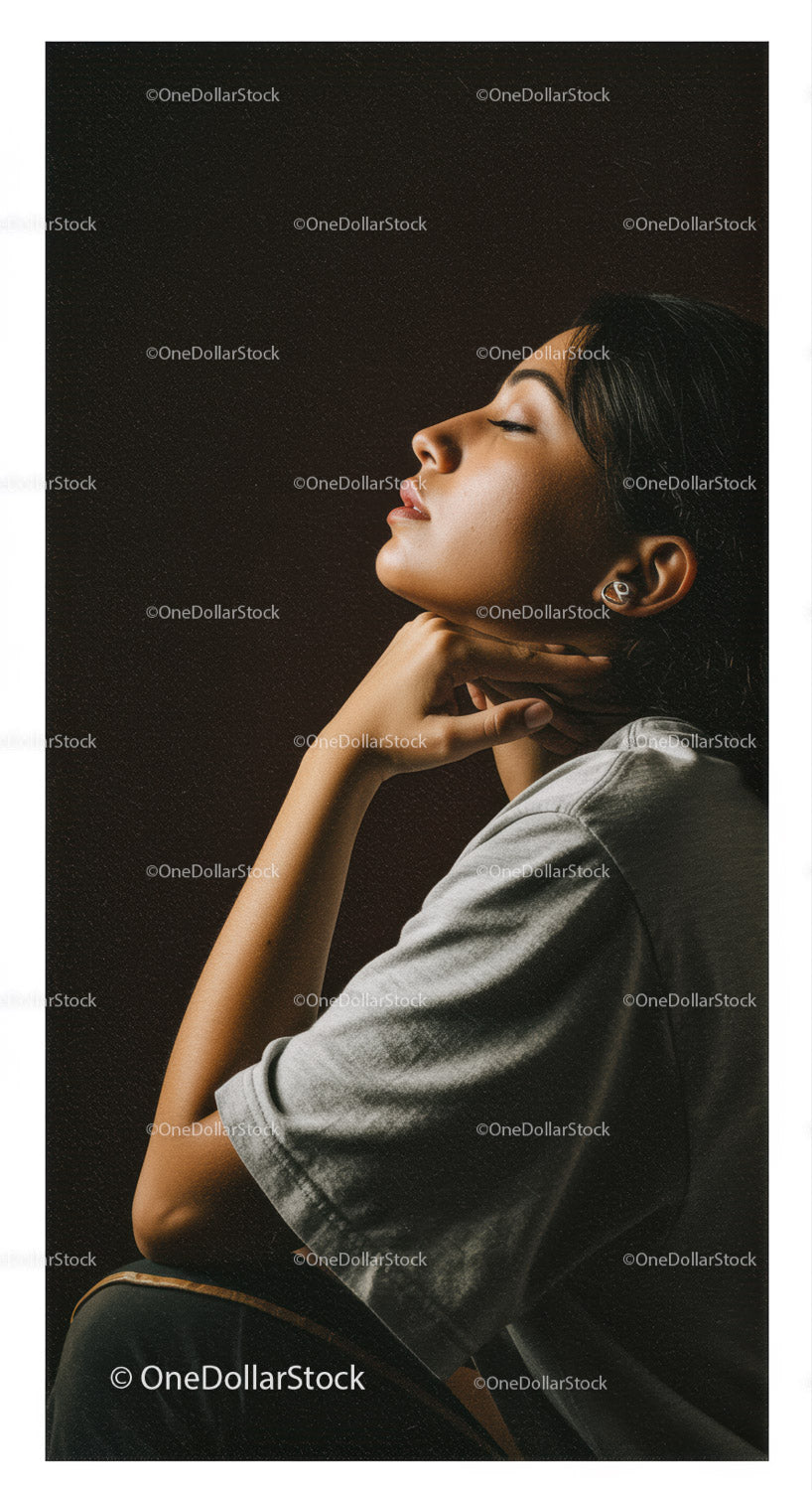 Elegant Woman in Profile with Soft Lighting Against Dark Background