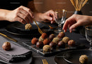 Elegant Chocolate Truffles and Gourmet Sweets on Black Marble Platter