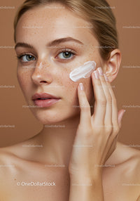 Close-up of Young Woman Applying Face Cream for Natural Beauty