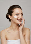 Young Woman Applying Face Cream for Skincare Routine with Smooth Skin