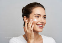 Smiling Woman Applying Moisturizer Facial Skincare Routine