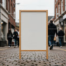 Blank wooden framed signboard on cobblestone street