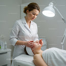 Skincare Professional Performing Facial Treatment on Woman in Spa
