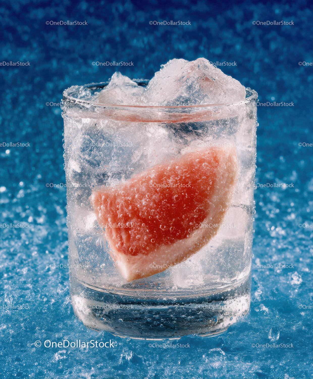 Refreshing Grapefruit Slice with Ice Cubes in a Clear Glass