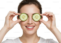 Smiling woman enjoying a refreshing cucumber beauty mask for skincare