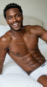 Smiling man relaxing on bed in white underwear