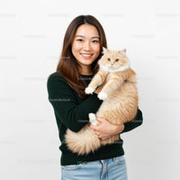 Smiling woman holding fluffy cream cat indoors