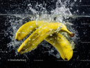 Yellow Bananas Splashing into Water in Vibrant High-Resolution Image