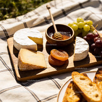 Cheese Platter with Honey, Dried Apricots, and Grapes