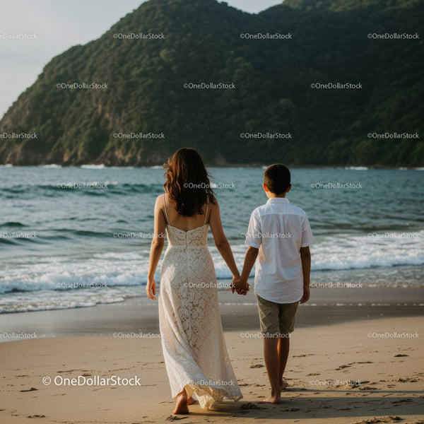 Woman and Child Walking Hand in Hand Along the Sunny Beach Coast