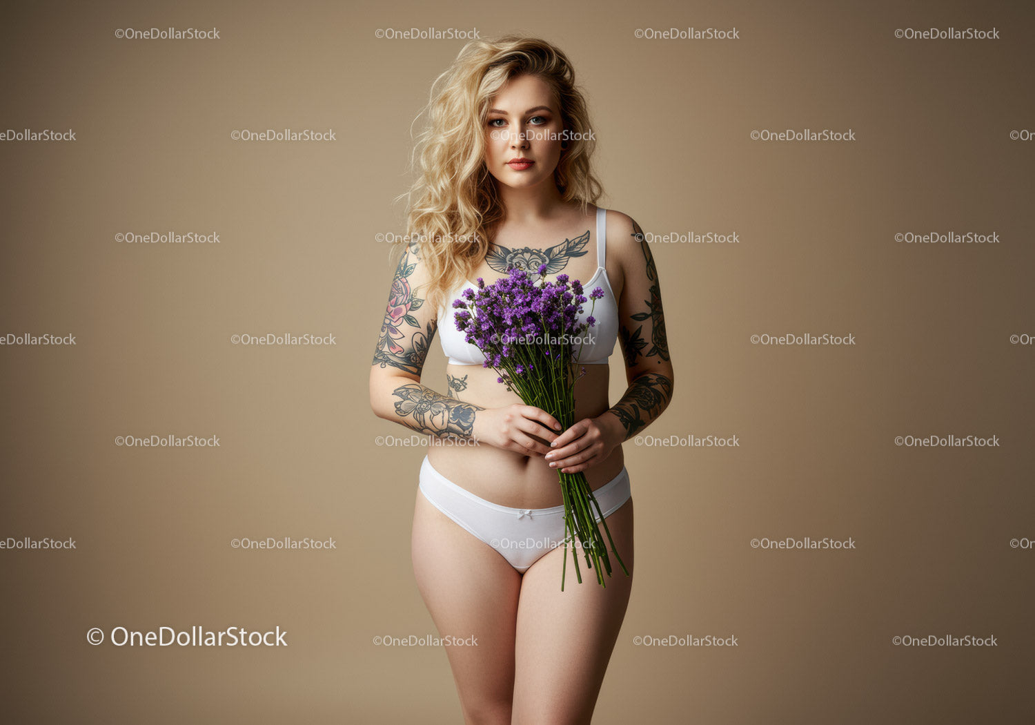 Young Woman with Tattoos Holding Purple Flowers In Studio