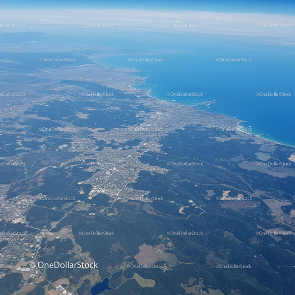 Aerial View of Coastal Landscape with Forests and Ocean Shoreline