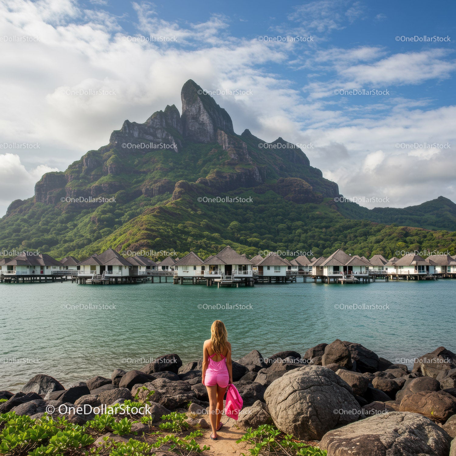 Scenic Overwater Bungalows with Lush Mountain and Woman in Pink Swimsuit