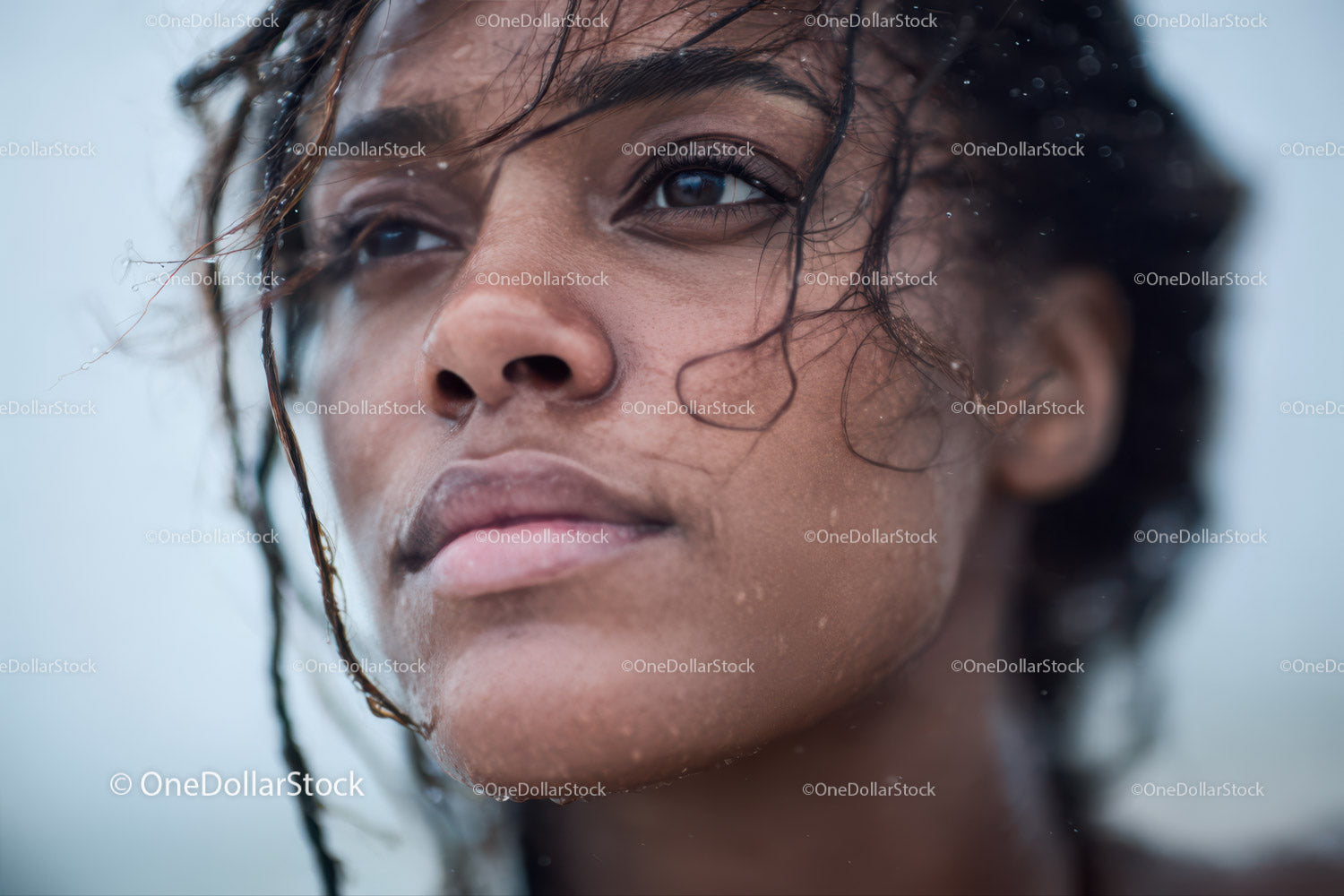 Close-up of a Woman's Face with Wet Hair and Natural Water Splash