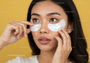 Close-up of Woman Applying Eye Patches for Skin Rejuvenation