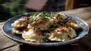 Plate of Traditional Polish Pierogi Garnished with Herbs on Wooden Table
