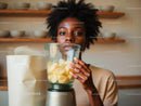 Woman holding banana slices in a glass jar with wooden shelves