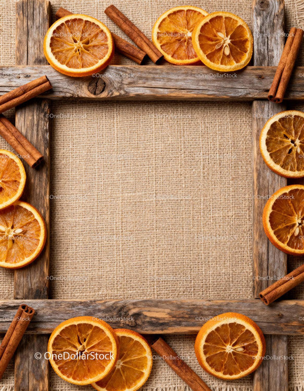 Rustic wooden frame with dried orange slices and cinnamon sticks
