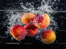 Fresh Juicy Peaches Splashing into Water