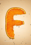 Fresh orange slice shaped as letter F with water drops