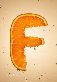 Fresh orange slice shaped as letter F with water drops