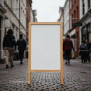 Blank wooden signboard on cobblestone city street