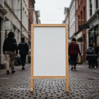 Blank wooden signboard on cobblestone city street