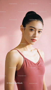 Focused young ballerina posing gracefully indoors
