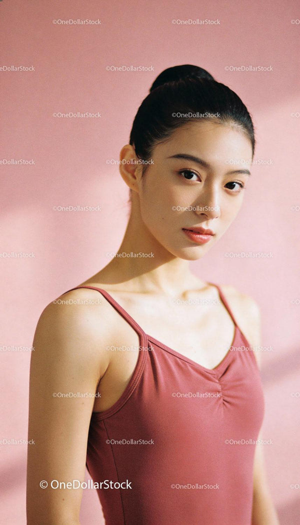 Focused young ballerina posing gracefully indoors
