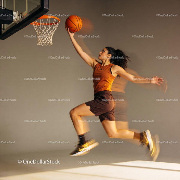 Female basketball player jumping for a layup shot