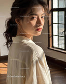 Young woman bathed in soft natural window light