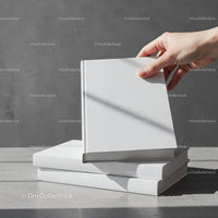 Hand Picking Blank White Hardcover Book from Stack