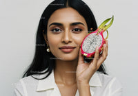 Woman Holding Juicy Dragon Fruit in Front of White Minimalist Background