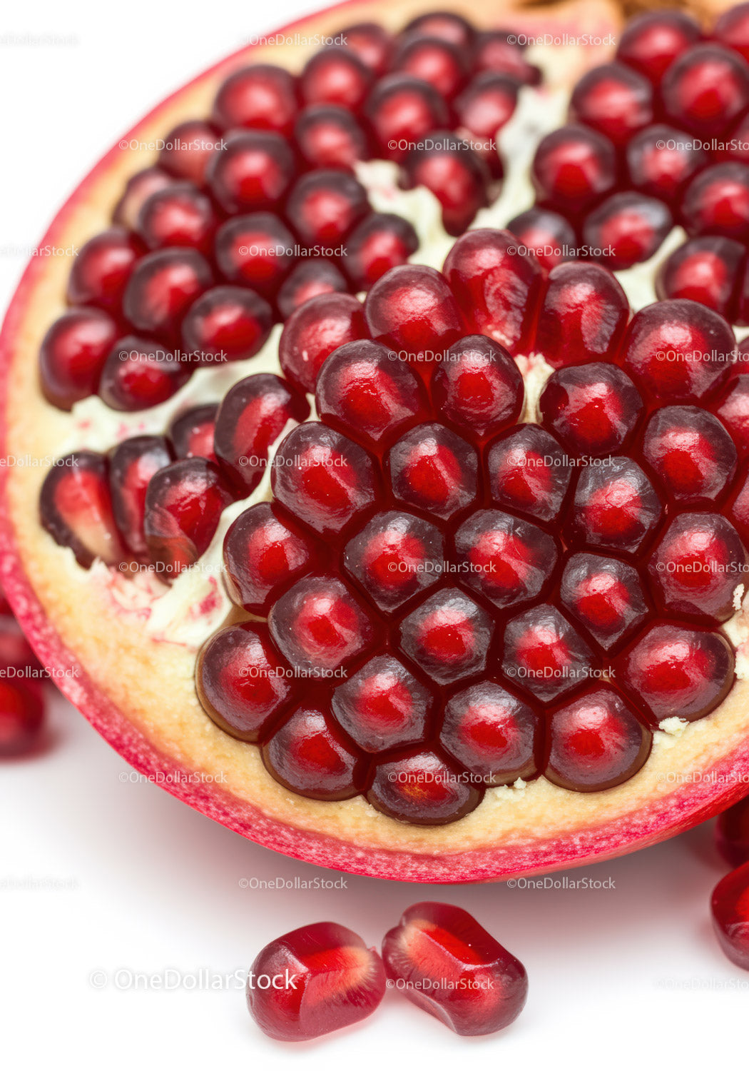 Close up of ripe pomegranate seeds on white background
