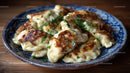 Fried Dumplings with Green Garnish on a Blue Ceramic Plate